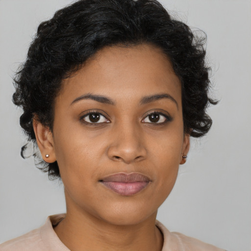Joyful black young-adult female with short  brown hair and brown eyes