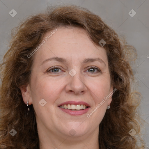 Joyful white adult female with medium  brown hair and blue eyes