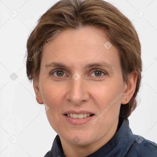 Joyful white adult female with medium  brown hair and grey eyes