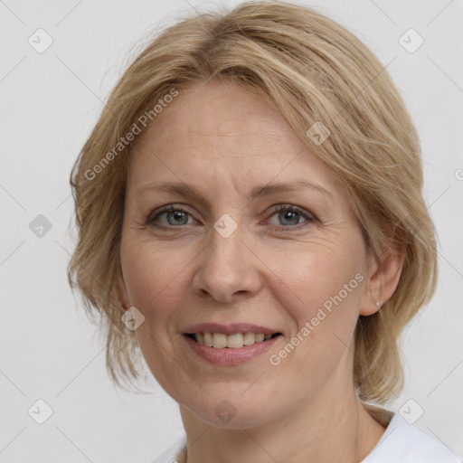 Joyful white adult female with medium  brown hair and grey eyes