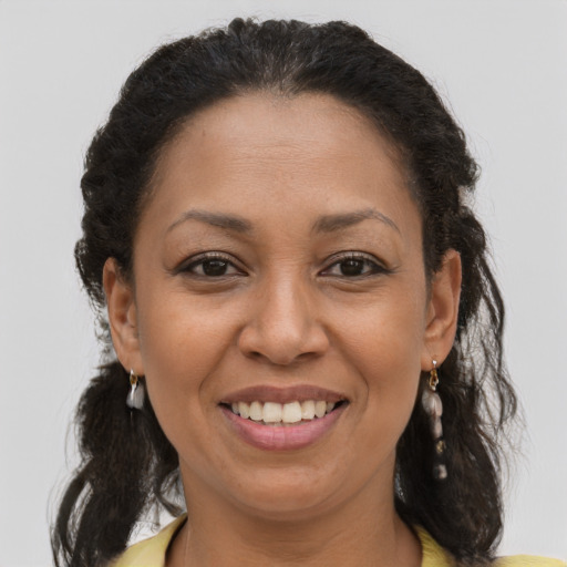 Joyful latino adult female with medium  brown hair and brown eyes
