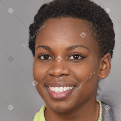 Joyful black young-adult female with short  brown hair and brown eyes