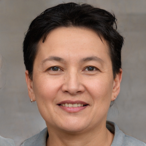 Joyful white adult female with short  brown hair and brown eyes