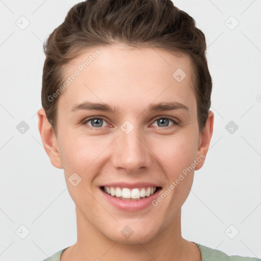 Joyful white young-adult female with short  brown hair and grey eyes