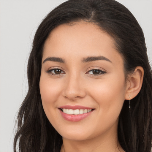 Joyful white young-adult female with long  brown hair and brown eyes