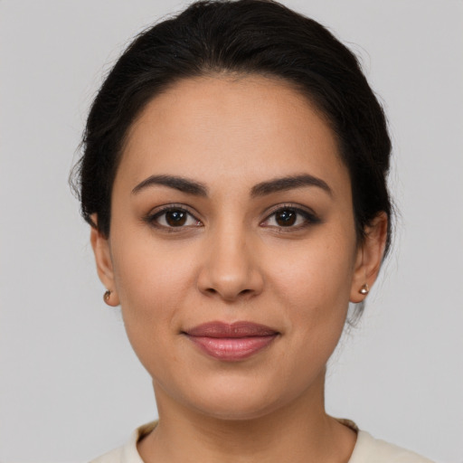 Joyful latino young-adult female with medium  brown hair and brown eyes
