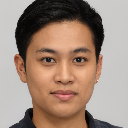 Joyful asian young-adult male with short  brown hair and brown eyes