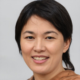 Joyful asian adult female with medium  brown hair and brown eyes