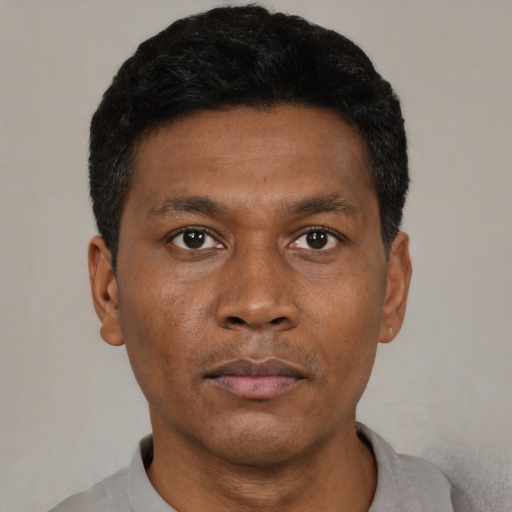 Neutral black adult male with short  black hair and brown eyes