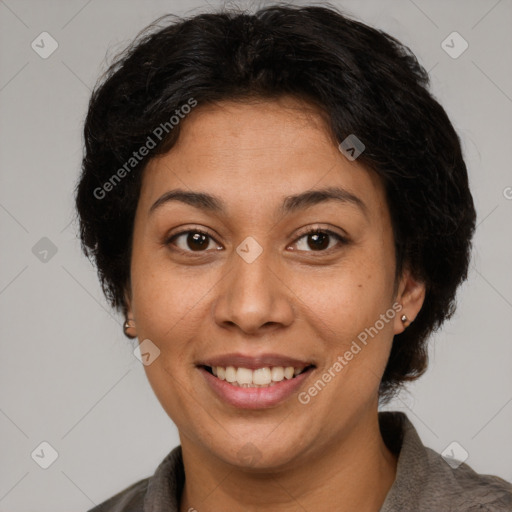 Joyful latino adult female with short  brown hair and brown eyes