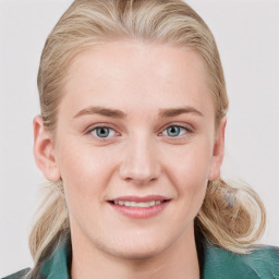 Joyful white young-adult female with long  brown hair and blue eyes