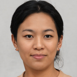 Joyful asian young-adult female with medium  black hair and brown eyes