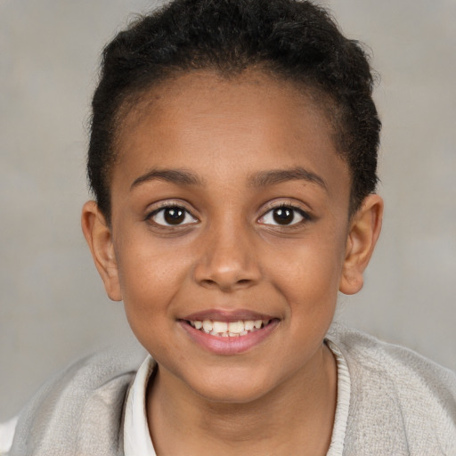 Joyful black child female with short  brown hair and brown eyes