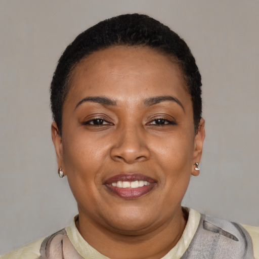 Joyful latino adult female with short  black hair and brown eyes