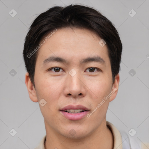 Joyful asian young-adult male with short  brown hair and brown eyes