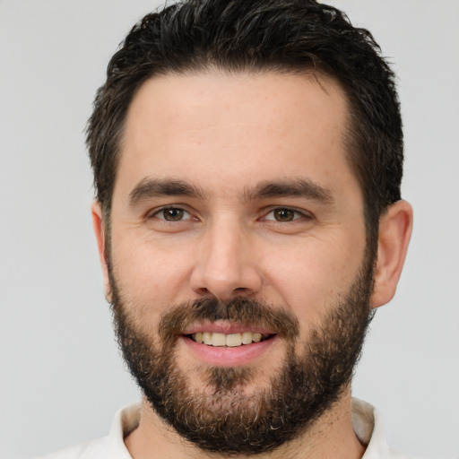 Joyful white young-adult male with short  brown hair and brown eyes