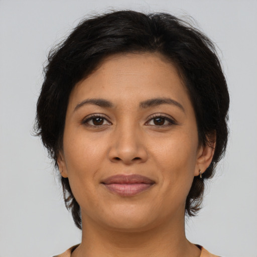 Joyful latino young-adult female with medium  brown hair and brown eyes
