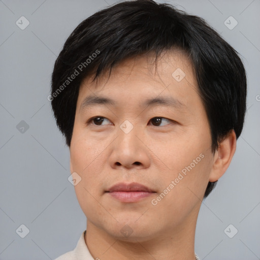 Joyful asian young-adult male with short  black hair and brown eyes