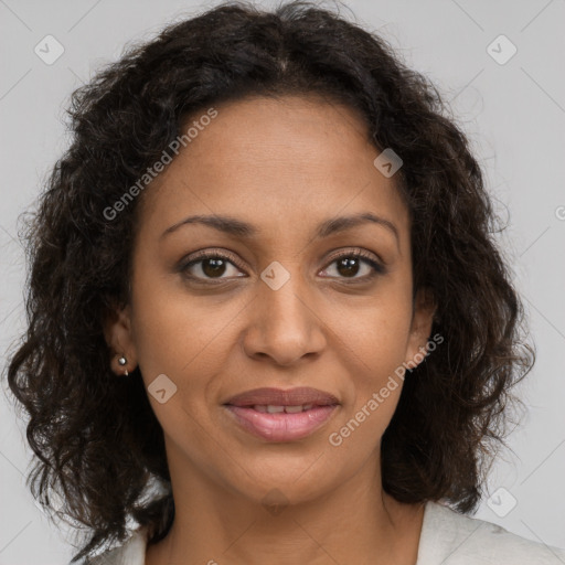 Joyful black adult female with medium  brown hair and brown eyes