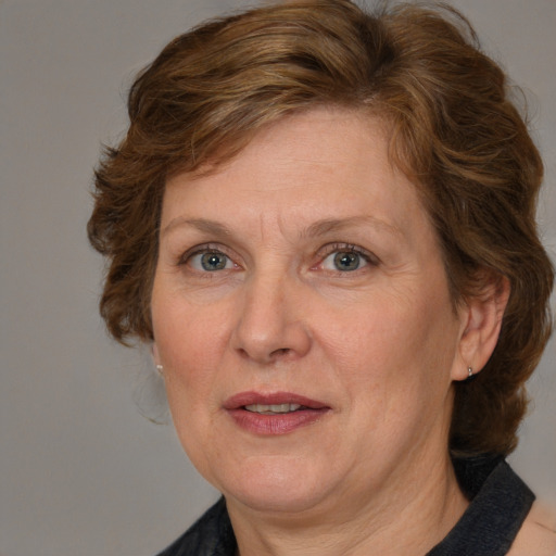 Joyful white adult female with medium  brown hair and blue eyes