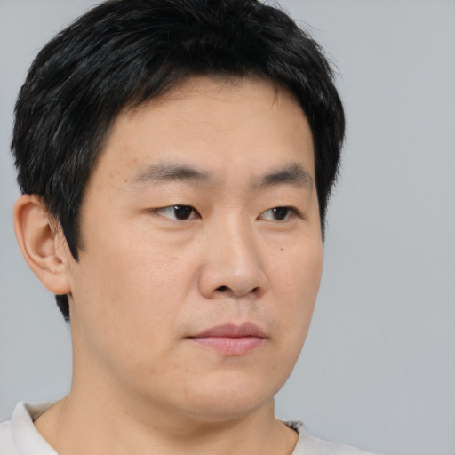 Neutral asian young-adult male with short  brown hair and brown eyes