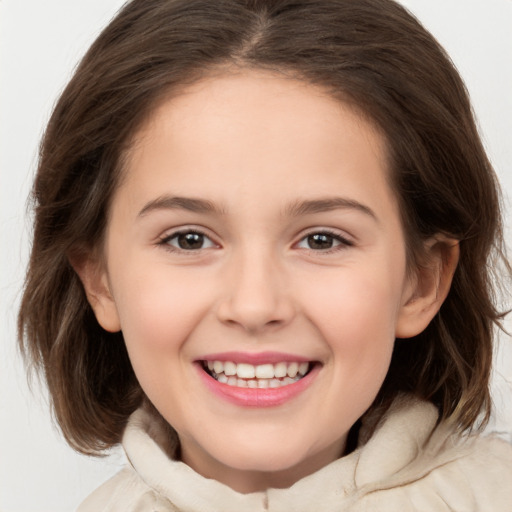 Joyful white child female with medium  brown hair and brown eyes