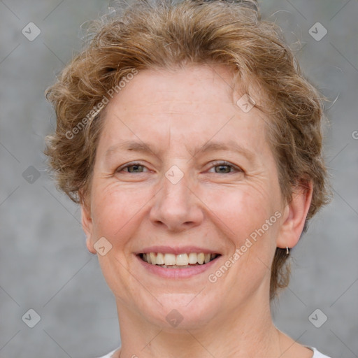 Joyful white adult female with short  brown hair and grey eyes