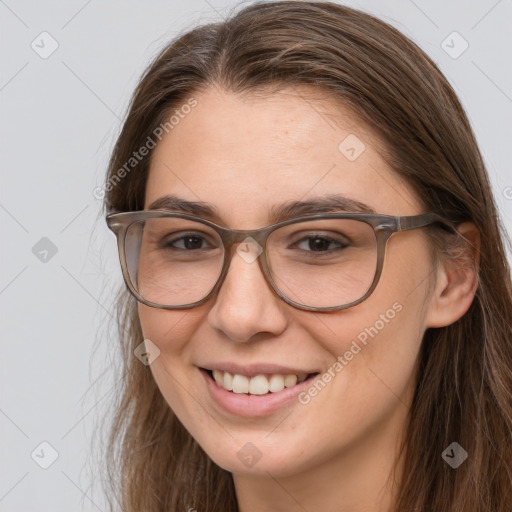 Joyful white adult female with long  brown hair and brown eyes