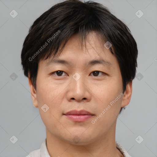 Joyful asian adult male with short  brown hair and brown eyes