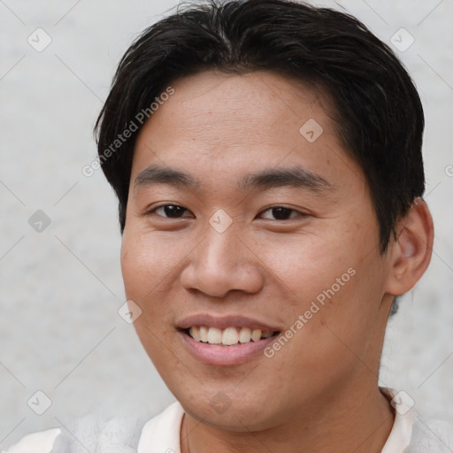 Joyful asian young-adult male with short  brown hair and brown eyes