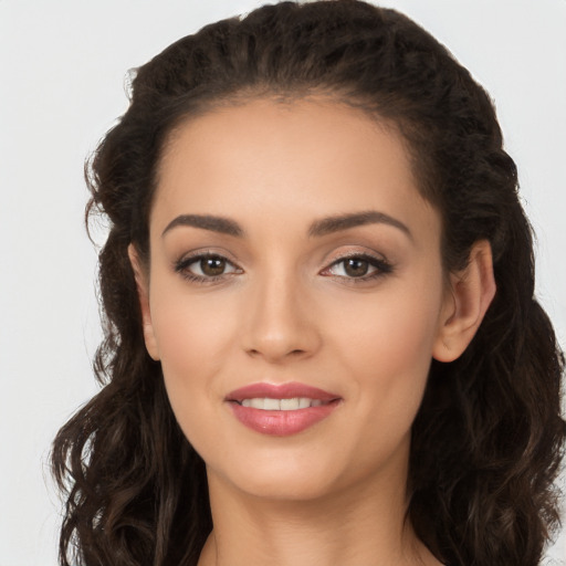 Joyful white young-adult female with long  brown hair and brown eyes