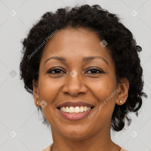 Joyful black adult female with short  brown hair and brown eyes