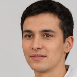 Joyful white young-adult male with short  black hair and brown eyes