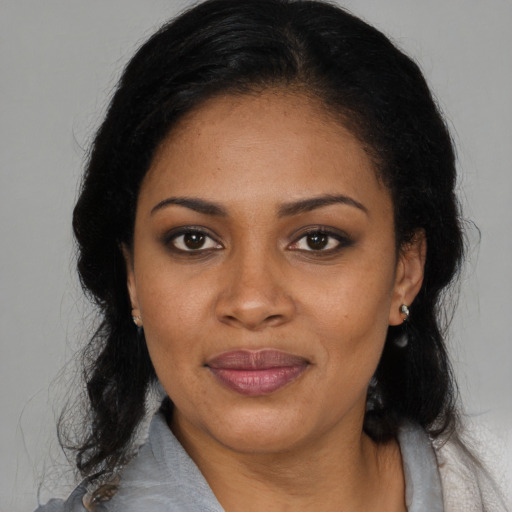 Joyful latino young-adult female with medium  black hair and brown eyes