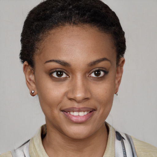 Joyful black young-adult female with short  brown hair and brown eyes