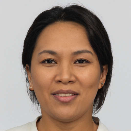 Joyful asian adult female with medium  brown hair and brown eyes