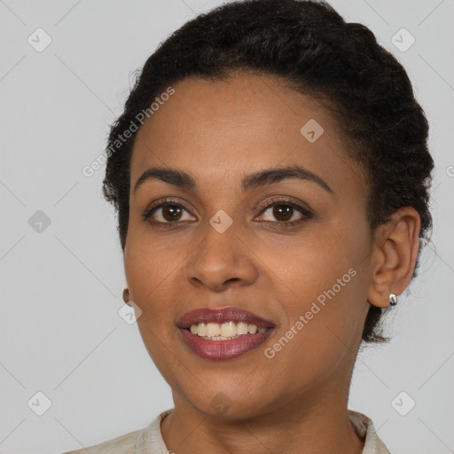 Joyful black young-adult female with short  brown hair and brown eyes