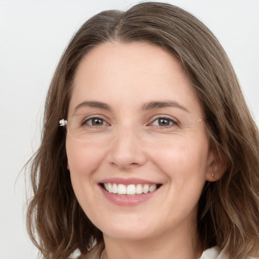 Joyful white young-adult female with long  brown hair and grey eyes