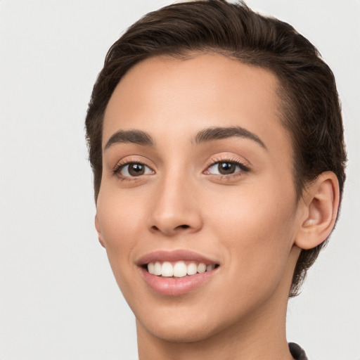 Joyful white young-adult female with short  brown hair and brown eyes