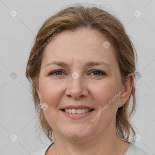 Joyful white adult female with medium  brown hair and grey eyes