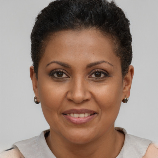 Joyful black young-adult female with short  brown hair and brown eyes