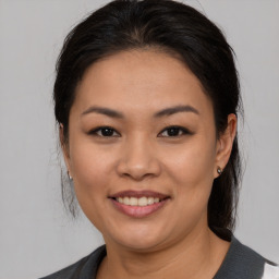 Joyful asian young-adult female with medium  brown hair and brown eyes