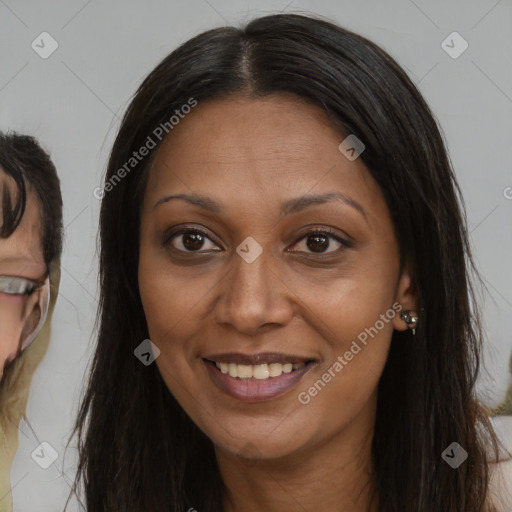 Joyful black adult female with long  brown hair and brown eyes