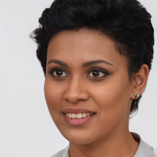 Joyful latino young-adult female with short  black hair and brown eyes