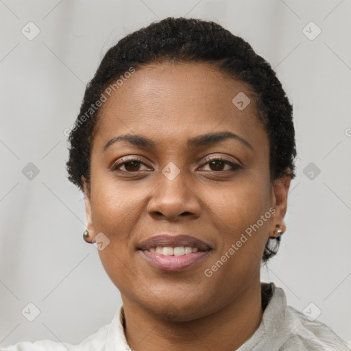 Joyful black young-adult female with short  brown hair and brown eyes