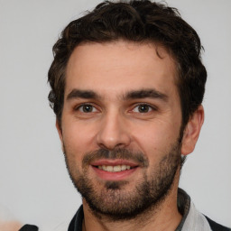 Joyful white young-adult male with short  black hair and brown eyes