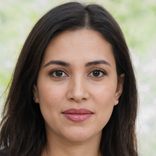 Joyful latino young-adult female with long  brown hair and brown eyes