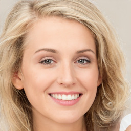 Joyful white young-adult female with long  brown hair and blue eyes