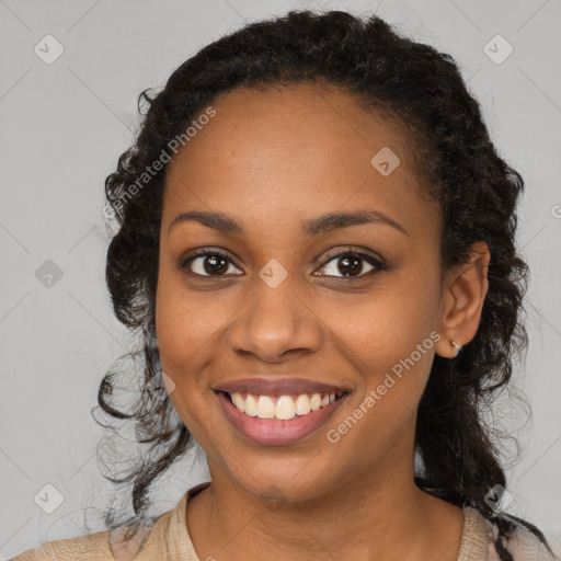 Joyful black young-adult female with long  brown hair and brown eyes