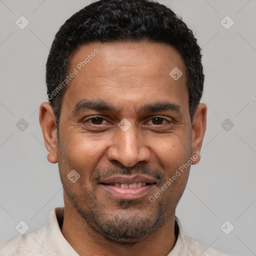 Joyful latino adult male with short  black hair and brown eyes